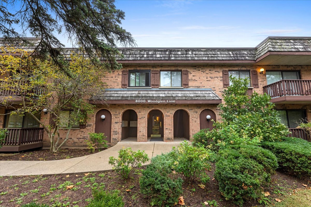 8000 Woodglen Lane, Unit 109 Downers Grove, IL 60516 - Photo 2 of 18 a view of a stone house with a small yard