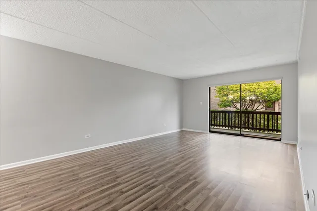 a view of a room with wooden floor and outdoor space