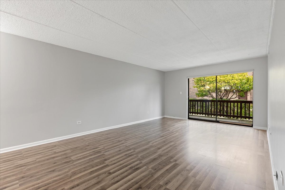 8000 Woodglen Lane, Unit 109 Downers Grove, IL 60516 - Photo 4 of 18 a view of a room with wooden floor and outdoor space