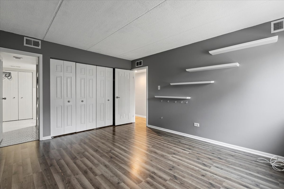 8000 Woodglen Lane, Unit 109 Downers Grove, IL 60516 - Photo 10 of 18 a view of an empty room with wooden floor