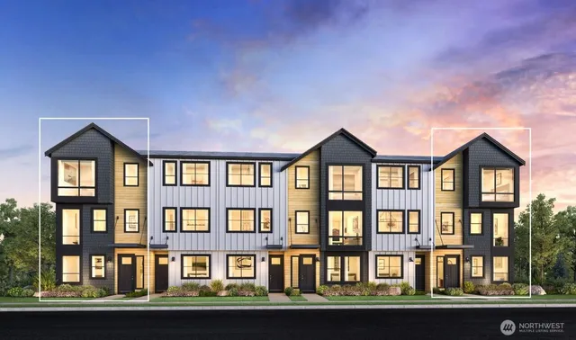 a front view of a residential apartment building with a yard