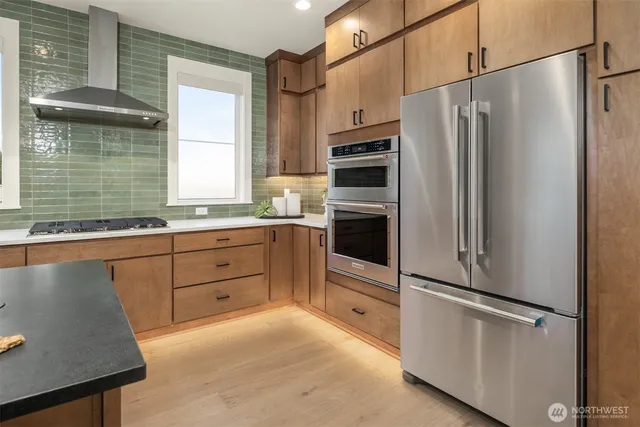 a kitchen with stainless steel appliances a refrigerator sink and cabinets