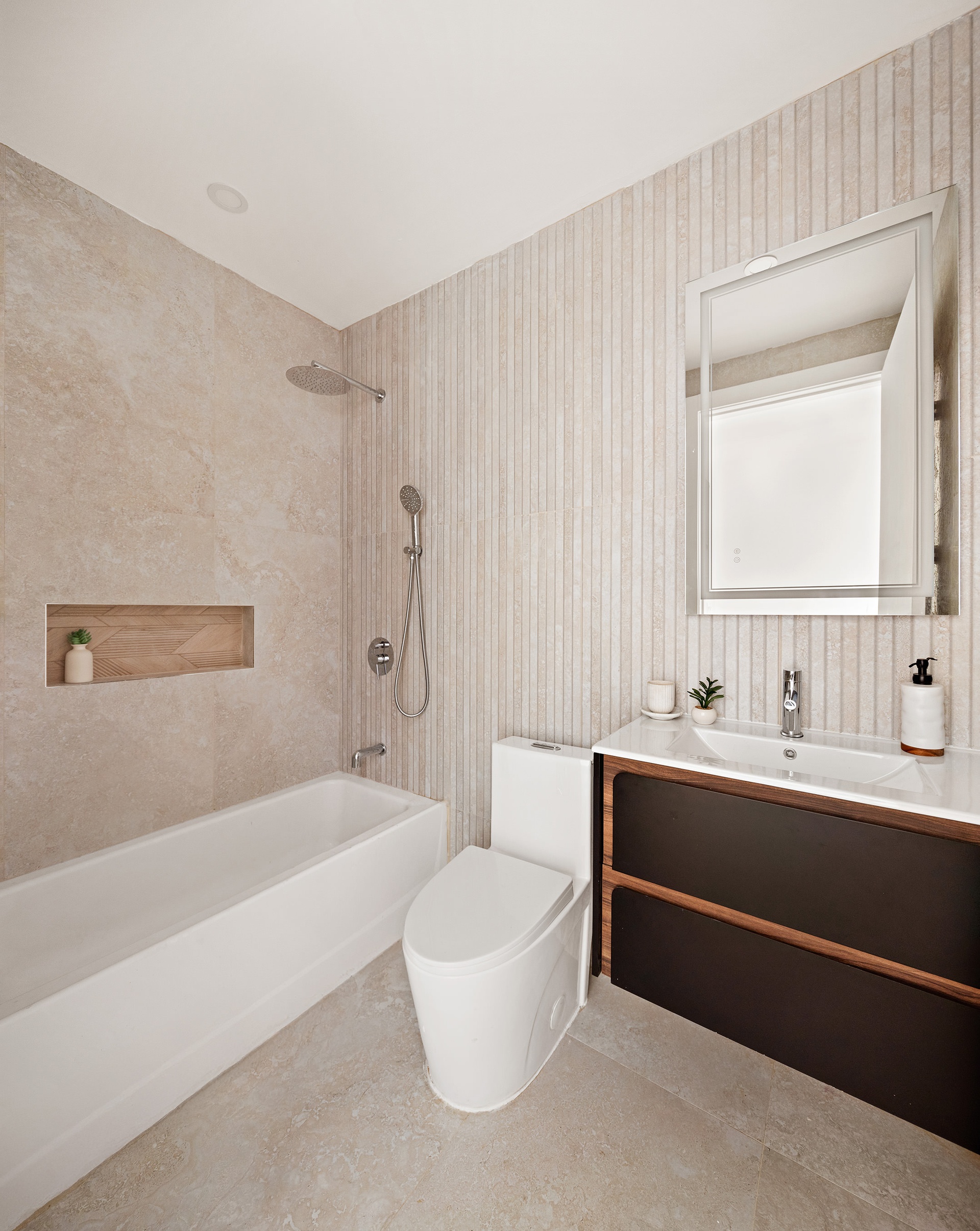 197 Pulaski Street, Unit PH Brooklyn, NY 11206 - Photo 4 of 8 a bathroom with a bathtub a mirror a sink and a shower