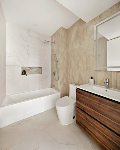 a bathroom with a bathtub sink and toilet