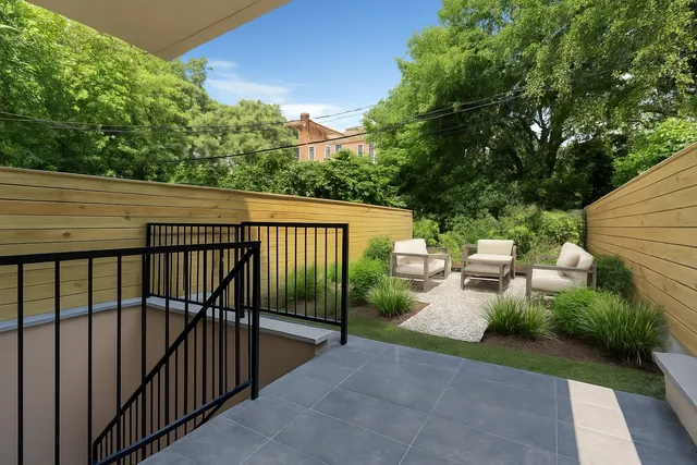 a view of a patio with table and chairs and potted plants