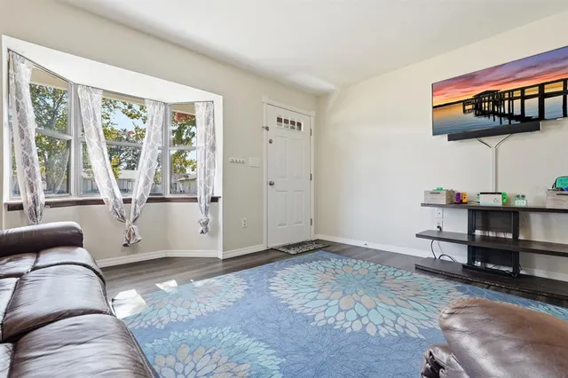 a kitchen with a refrigerator cabinets and wooden floor