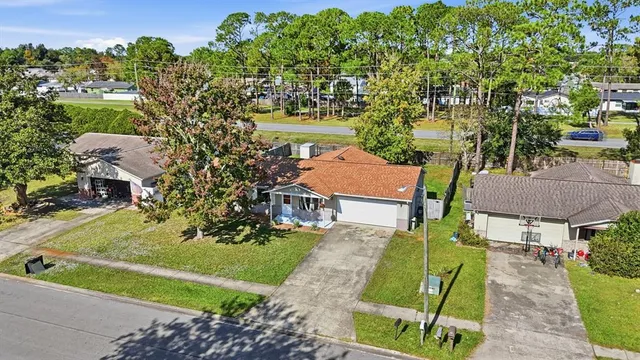 an aerial view of a house with a garden and swimming pool