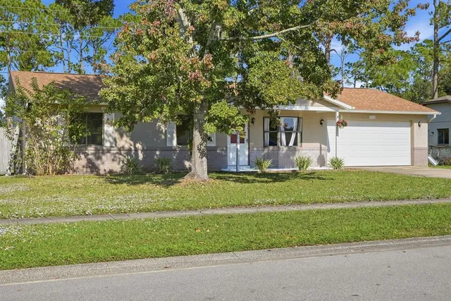 a front view of house with yard and green space
