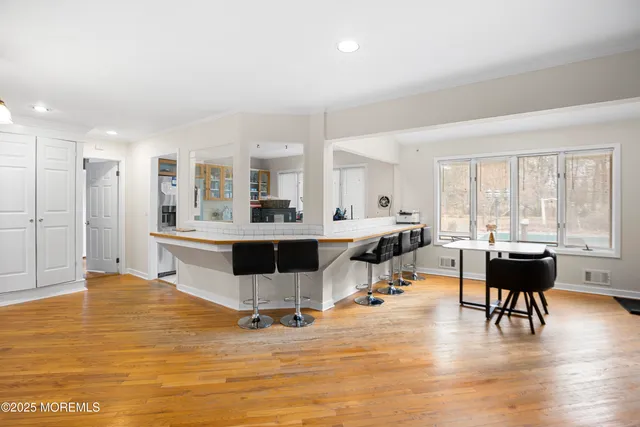 a living room with dining room and kitchen view