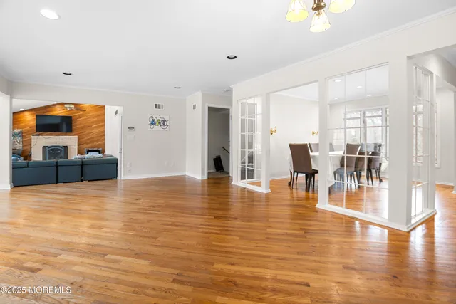 a view of a living room and kitchen with furniture and floor to ceiling window