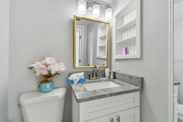 a bathroom with a sink a vanity and a mirror