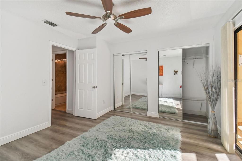 4427 Dylan Loop, Unit 190 Land O' Lakes, FL 34639 - Photo 16 of 26 wooden floor in an empty room with a bathroom