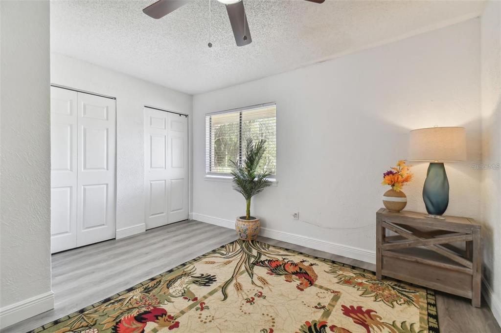 4427 Dylan Loop, Unit 190 Land O' Lakes, FL 34639 - Photo 19 of 26 a bedroom with a bed and wooden floor