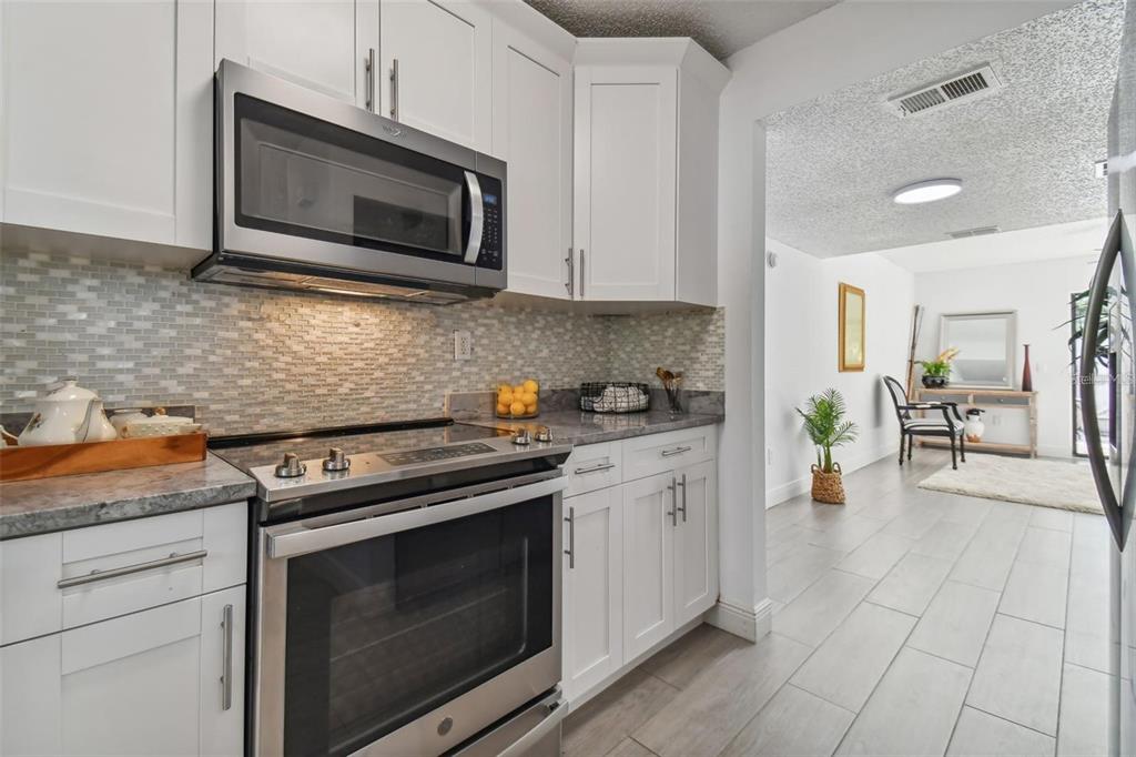 4427 Dylan Loop, Unit 190 Land O' Lakes, FL 34639 - Photo 2 of 26 a kitchen with stainless steel appliances a stove microwave and cabinets
