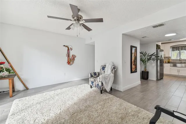 a view of a livingroom with furniture and a ceiling fan