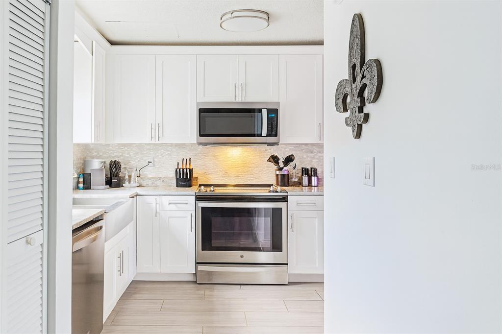 4427 Dylan Loop, Unit 190 Land O' Lakes, FL 34639 - Photo 7 of 26 a kitchen with white cabinets and stainless steel appliances