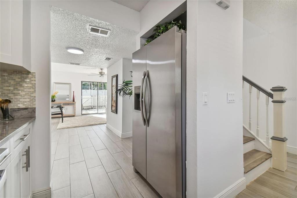 4427 Dylan Loop, Unit 190 Land O' Lakes, FL 34639 - Photo 9 of 26 a view of a hallway with wooden floor and a living room