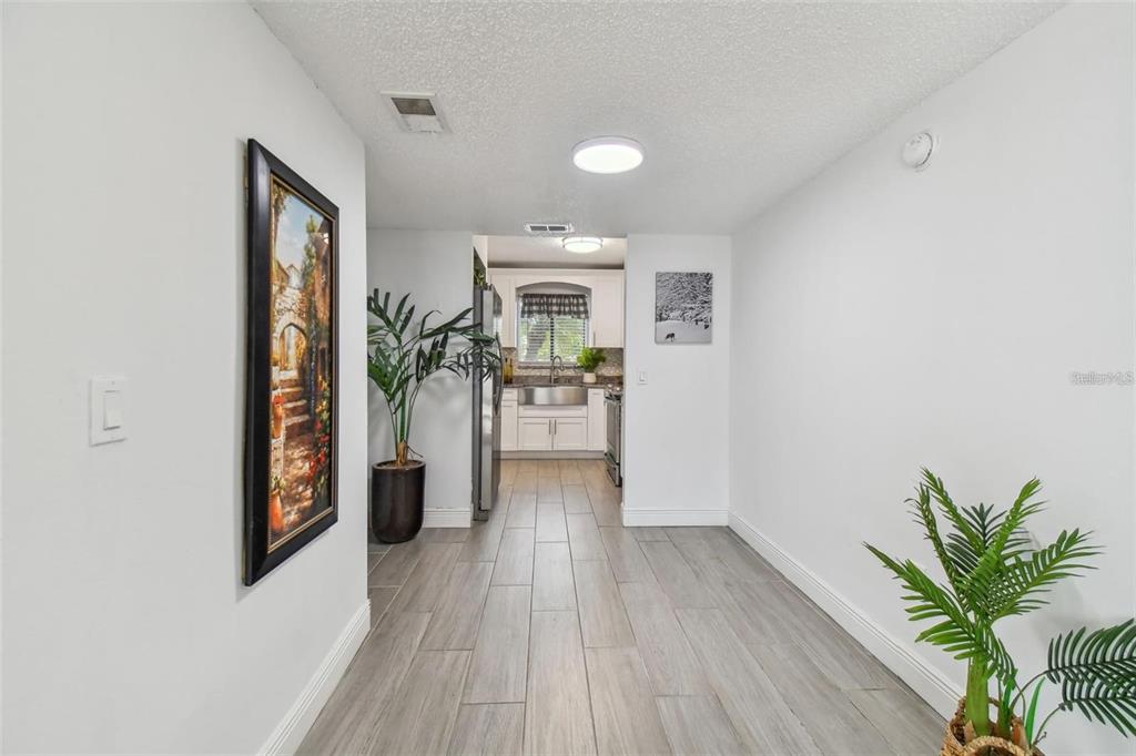 4427 Dylan Loop, Unit 190 Land O' Lakes, FL 34639 - Photo 10 of 26 a view of a hallway with wooden floor and a living room