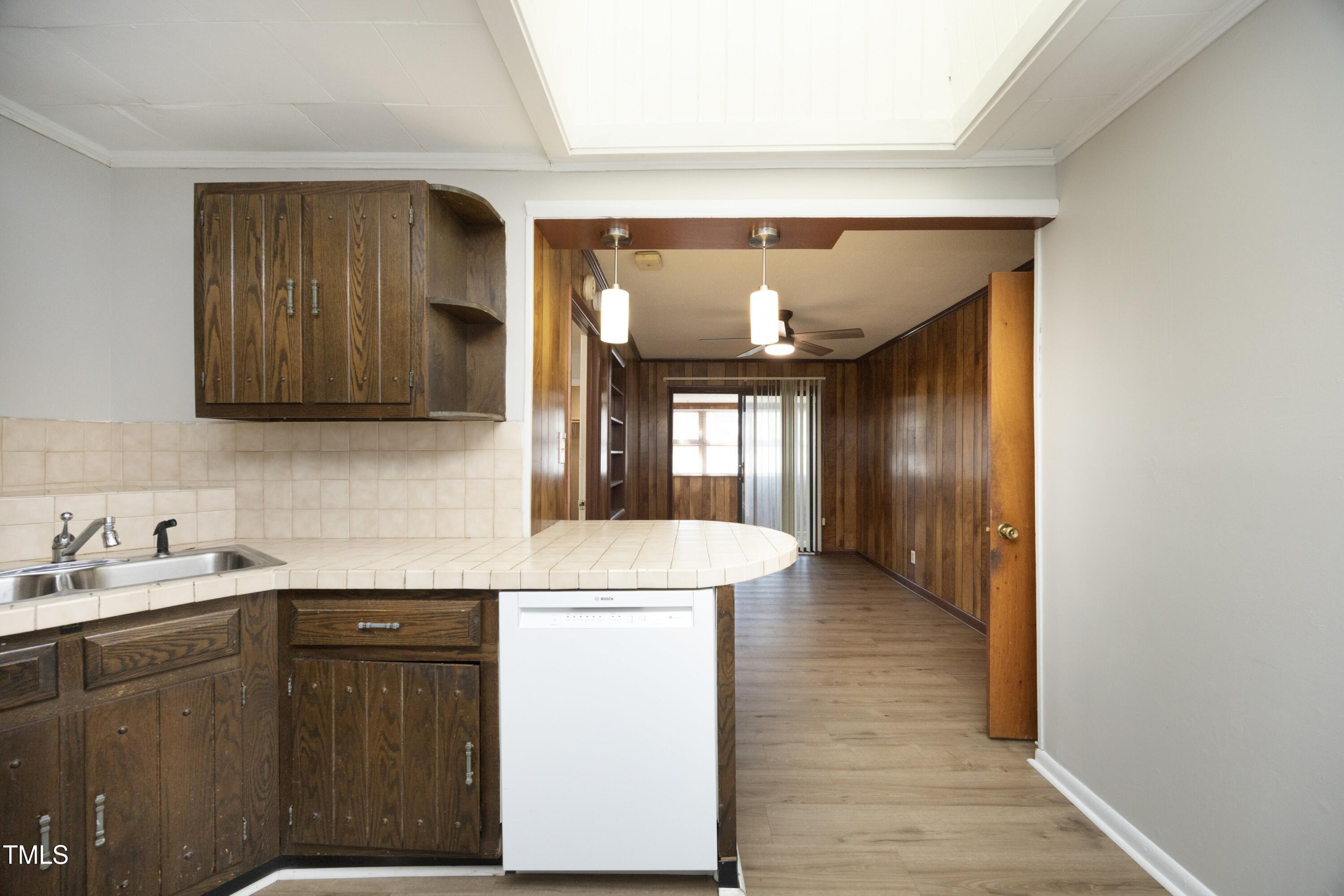 608 Cecil Street Durham, NC 27707 - Photo 11 of 31 a kitchen with a sink and cabinets