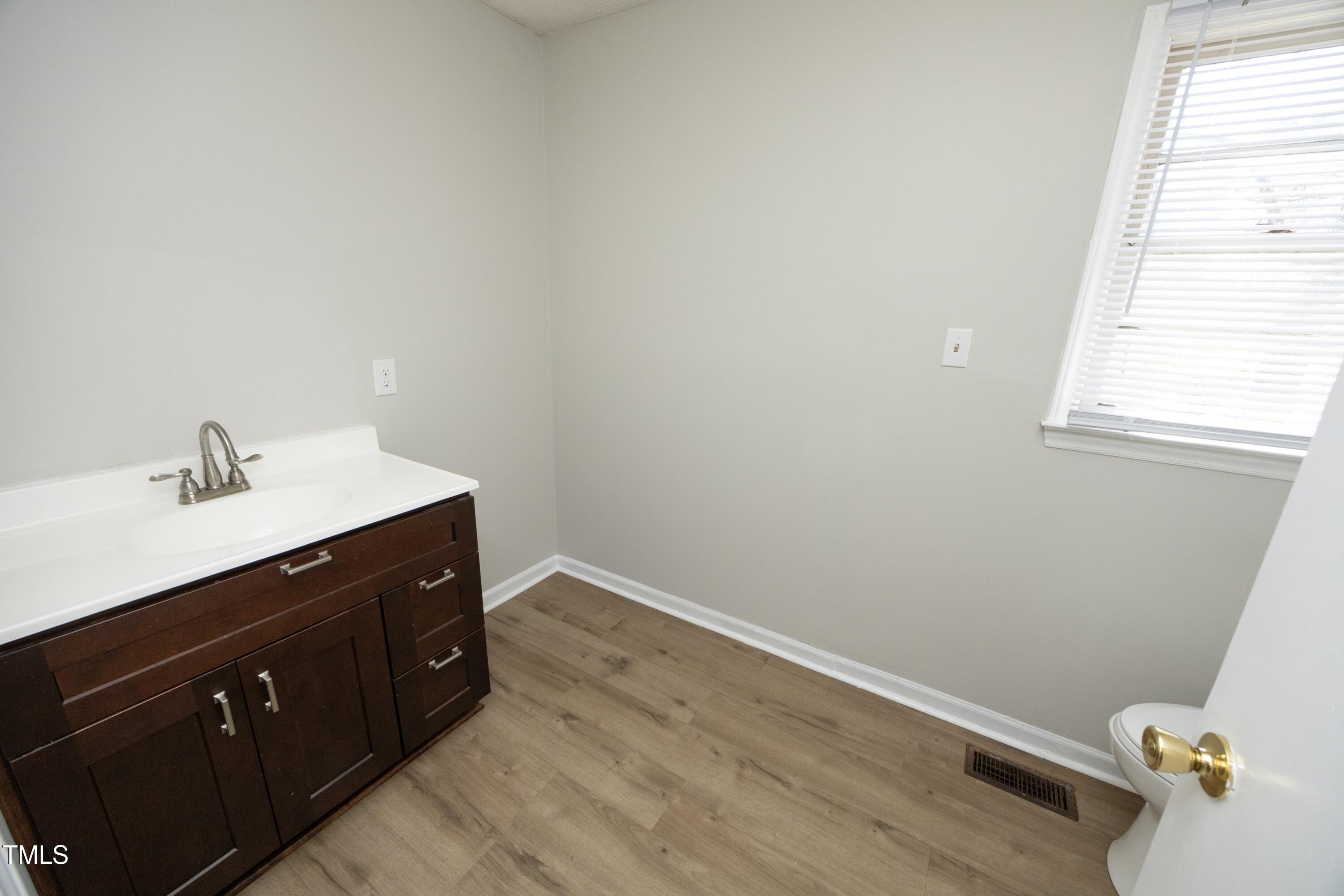 608 Cecil Street Durham, NC 27707 - Photo 22 of 31 a bathroom with a sink and a vanity