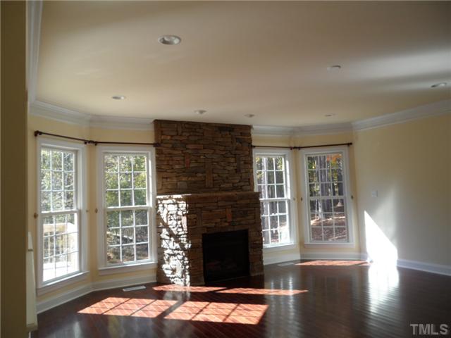 2037 Macon Ridge Road Raleigh, NC 27613 - Photo 11 of 25 a living room with fireplace and wooden floor