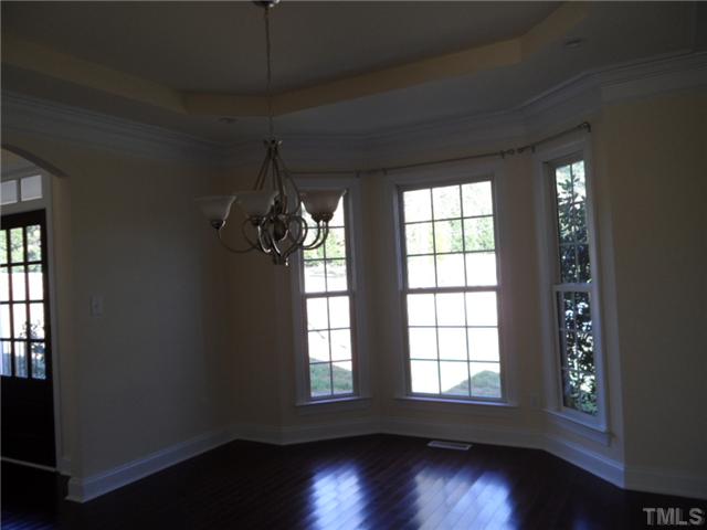 2037 Macon Ridge Road Raleigh, NC 27613 - Photo 7 of 25 an empty room with wooden floor and windows
