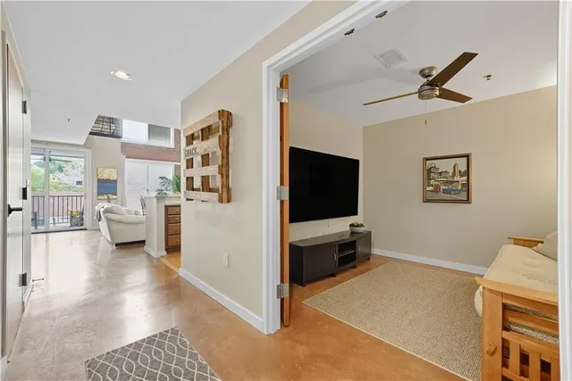 a view of a livingroom with furniture and a flat screen tv