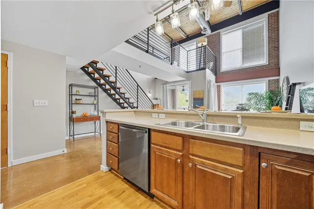 a kitchen with stainless steel appliances granite countertop a sink and a stove