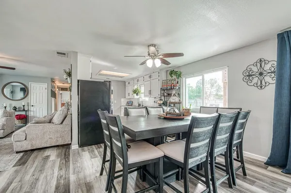 a living room with furniture and a large window with wooden floor