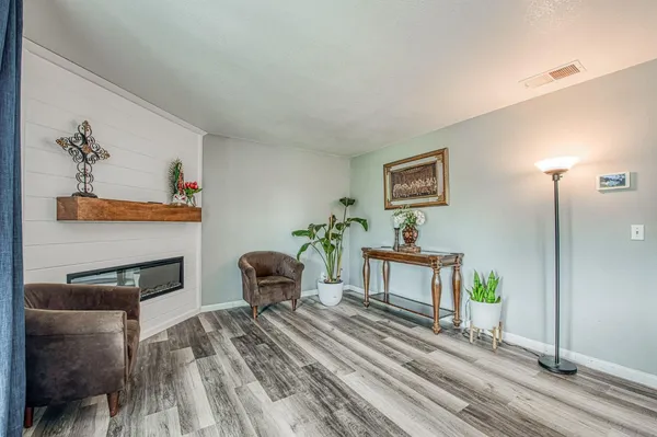 a kitchen with granite countertop a stove a sink dishwasher and cabinets with wooden floor