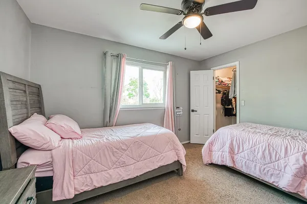 a bedroom with a bed dresser and a window