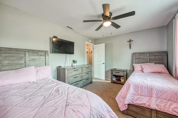 a bedroom with a bed and a chandelier