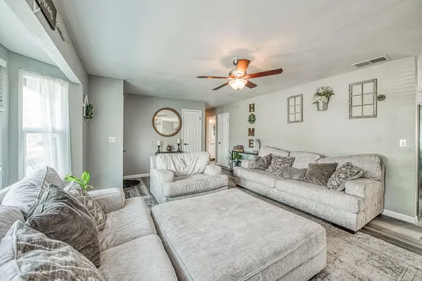a living room with furniture and a large window