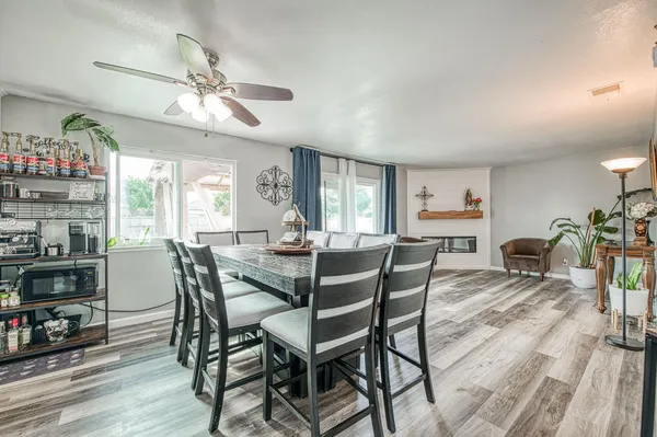 a view of a dining room with furniture and a large window