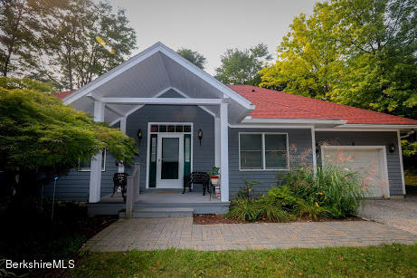 11 Prospect Hill Road, Unit 2 Stockbridge, MA 01262 - Photo 1 of 53 a front view of a house with a garden