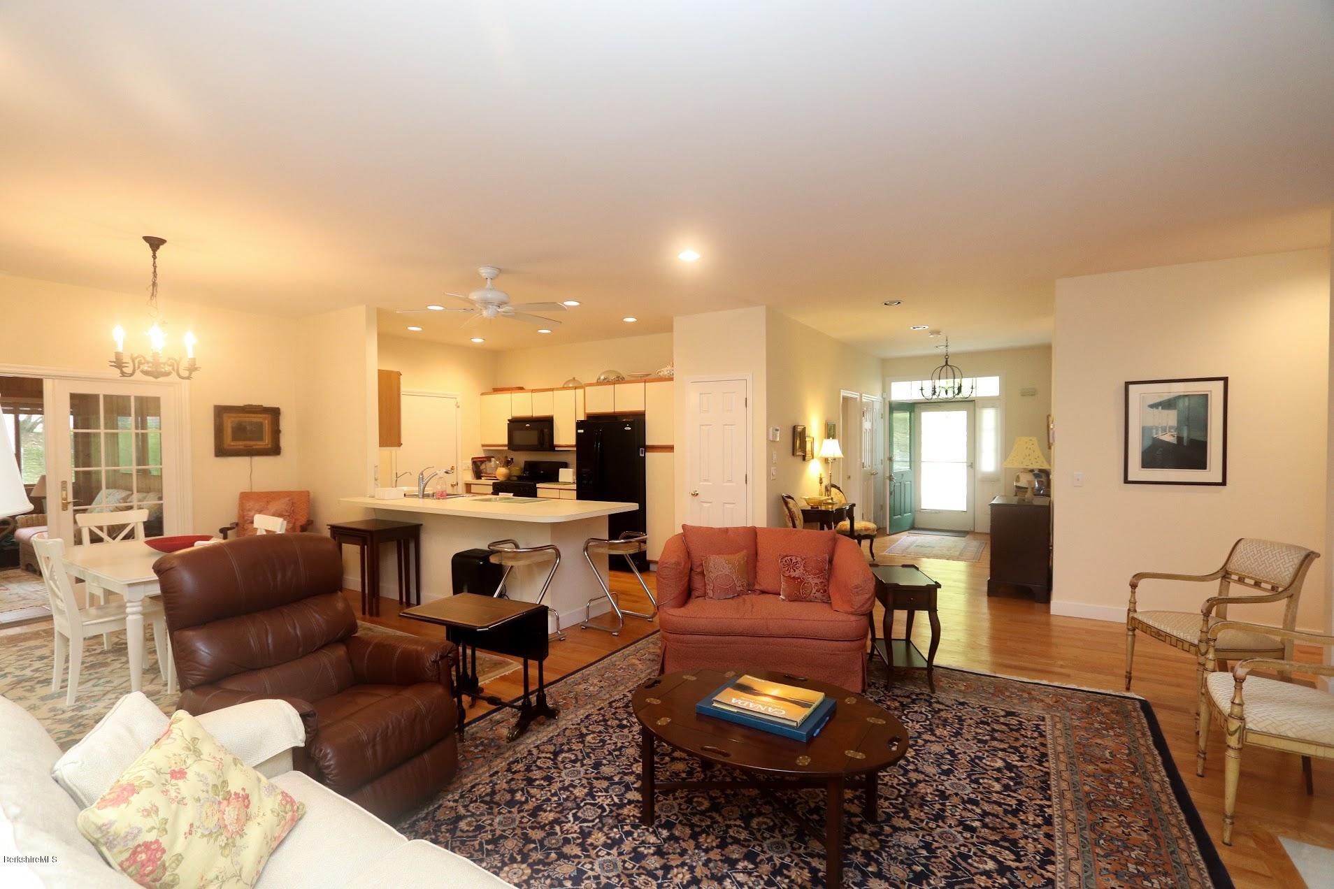11 Prospect Hill Road, Unit 2 Stockbridge, MA 01262 - Photo 2 of 53 a living room with furniture kitchen view and a table