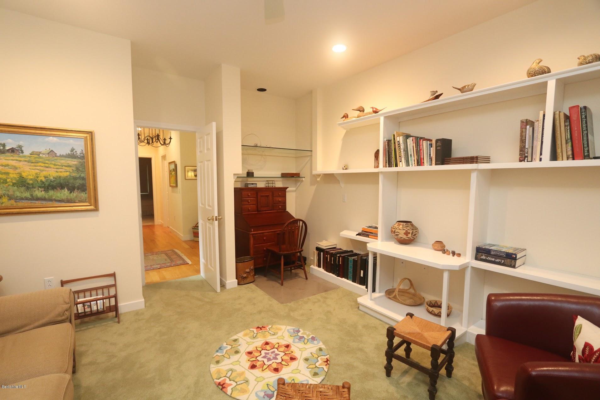 11 Prospect Hill Road, Unit 2 Stockbridge, MA 01262 - Photo 17 of 53 a living room with furniture a rug and white walls