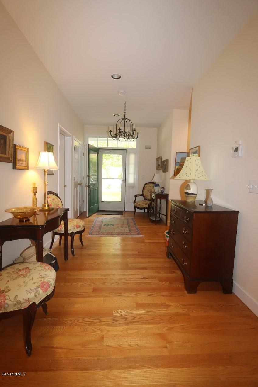 11 Prospect Hill Road, Unit 2 Stockbridge, MA 01262 - Photo 18 of 53 a living room with furniture and a chandelier