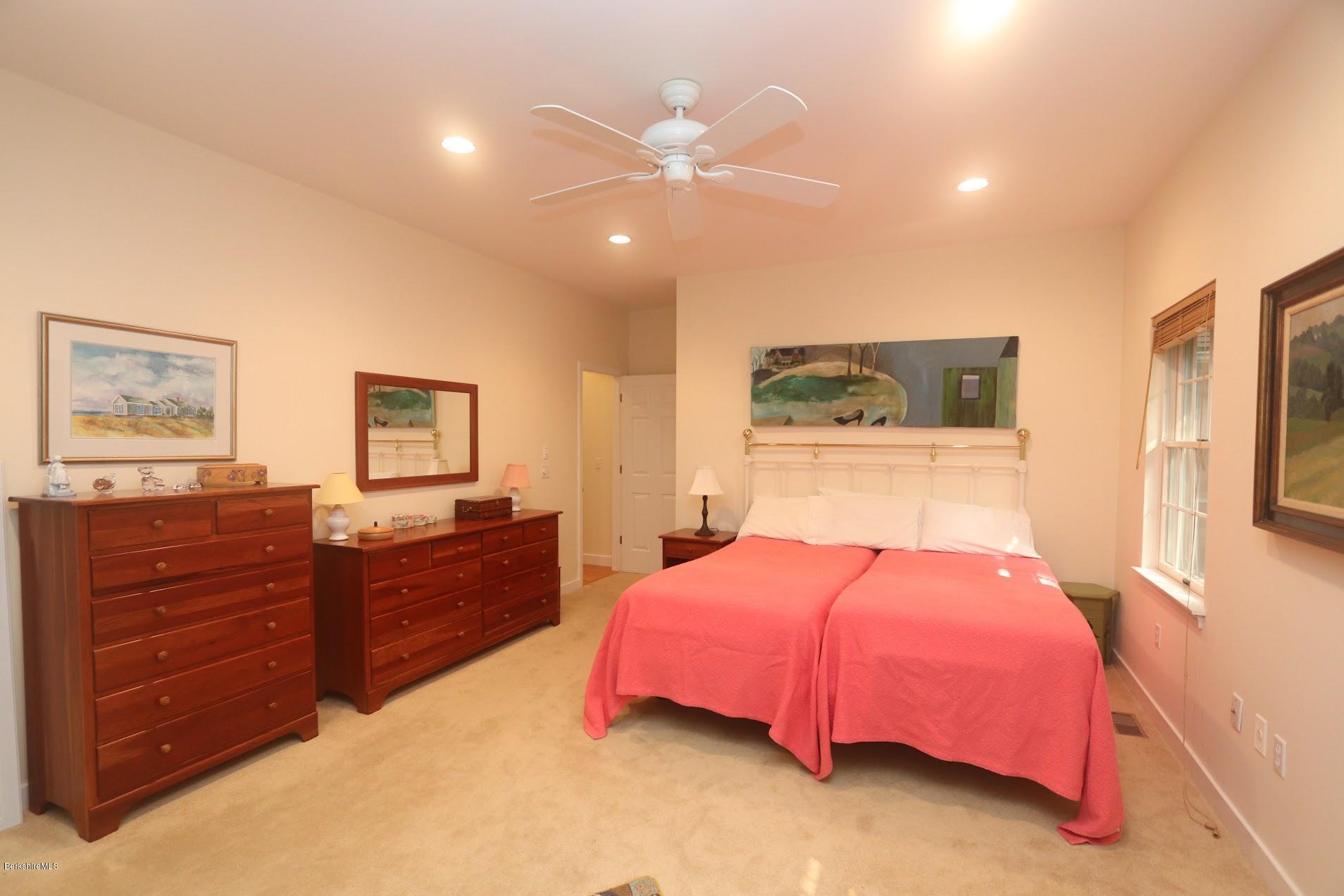 11 Prospect Hill Road, Unit 2 Stockbridge, MA 01262 - Photo 19 of 53 a bedroom with a bed and a chandelier