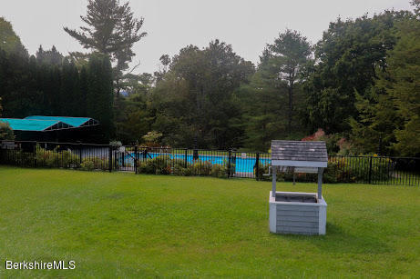 11 Prospect Hill Road, Unit 2 Stockbridge, MA 01262 - Photo 35 of 53 a backyard of a house with yard and trampoline