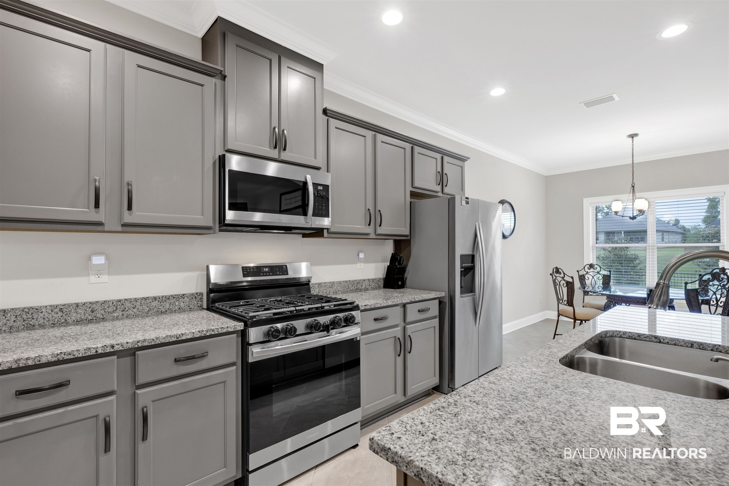 12672 Squirrel Drive Daphne, AL 36527 - Photo 12 of 49 Modern kitchen featuring gray cabinetry with dark hardware, stainless steel appliances, granite countertops, and recessed lighting