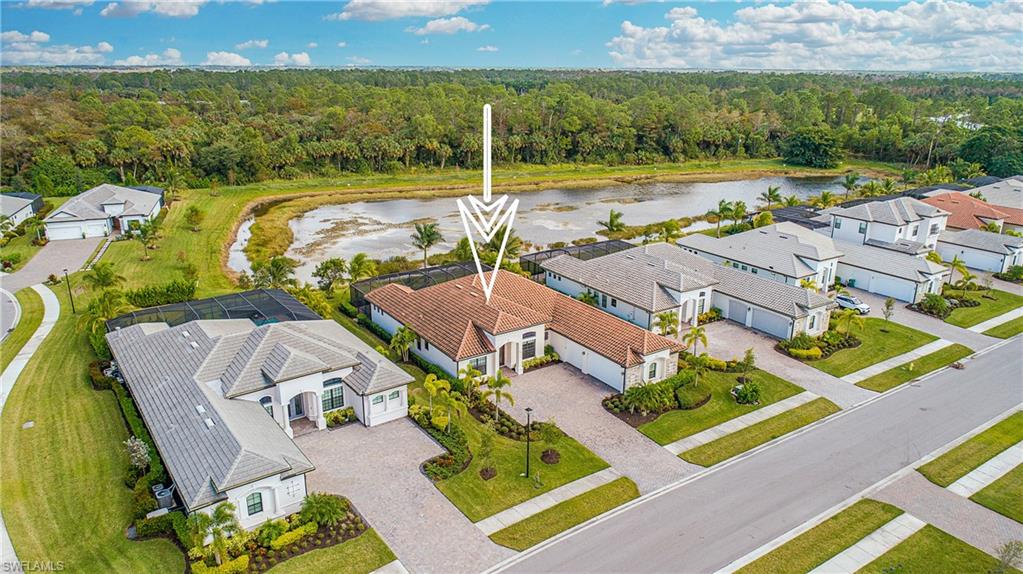 an aerial view of a house with a swimming pool and lake view