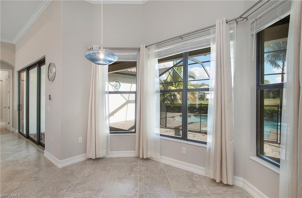 2247 Somerset Place Naples, FL 34120 - Photo 11 of 35 a view of livingroom with furniture large windows wooden floor and front door