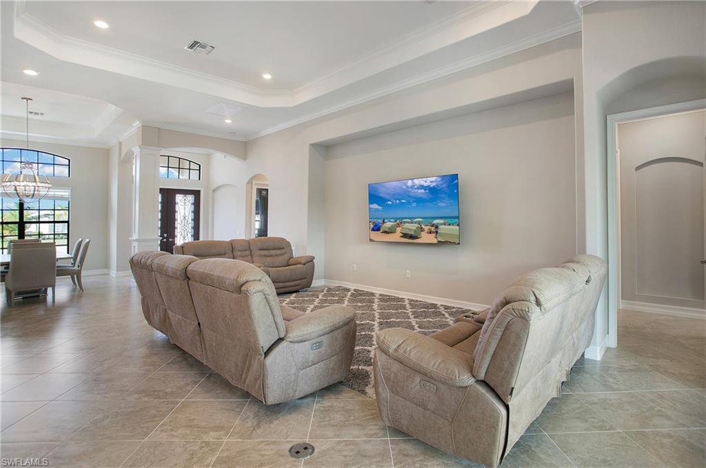 2247 Somerset Place Naples, FL 34120 - Photo 12 of 35 a living room with furniture and a flat screen tv