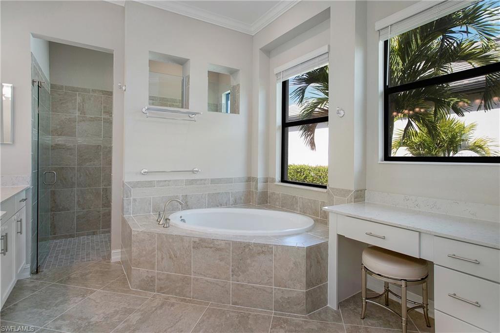 2247 Somerset Place Naples, FL 34120 - Photo 14 of 35 a bathroom with a sink a toilet and a bathtub