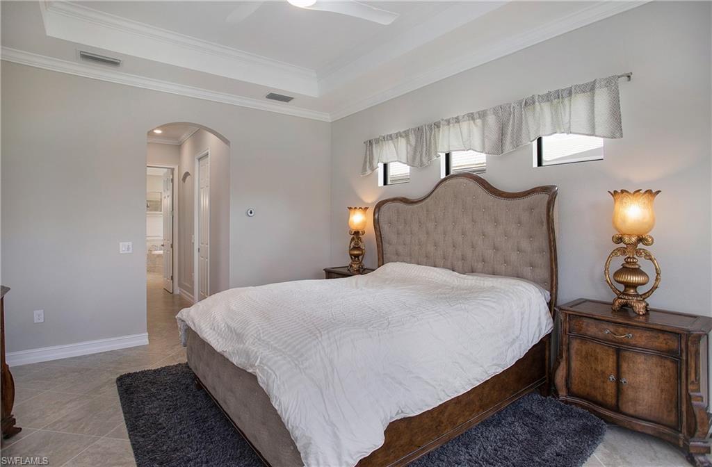 2247 Somerset Place Naples, FL 34120 - Photo 16 of 35 a bedroom with bed and a night stand