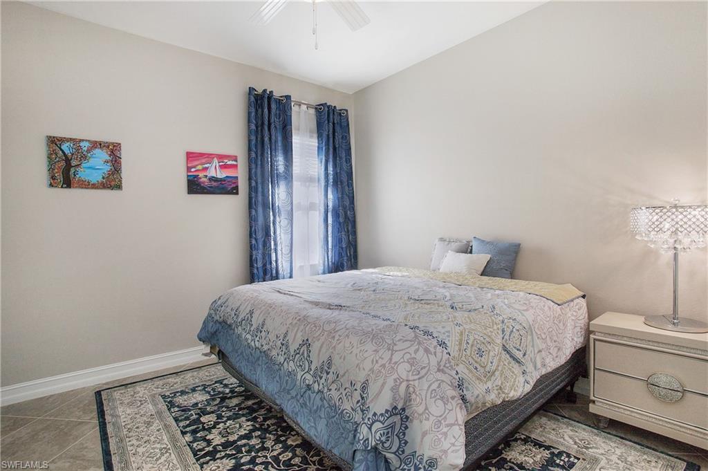 2247 Somerset Place Naples, FL 34120 - Photo 18 of 35 a bedroom with a bed and a window
