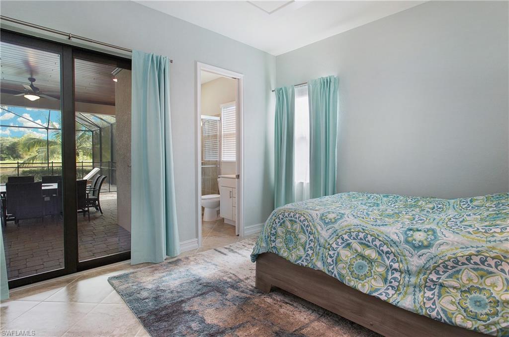2247 Somerset Place Naples, FL 34120 - Photo 20 of 35 a bedroom with a bed and a mirror