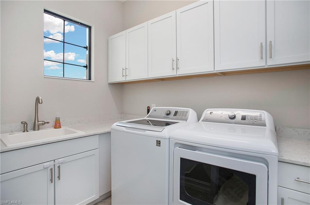 2247 Somerset Place Naples, FL 34120 - Photo 23 of 35 a utility room with dryer and washer