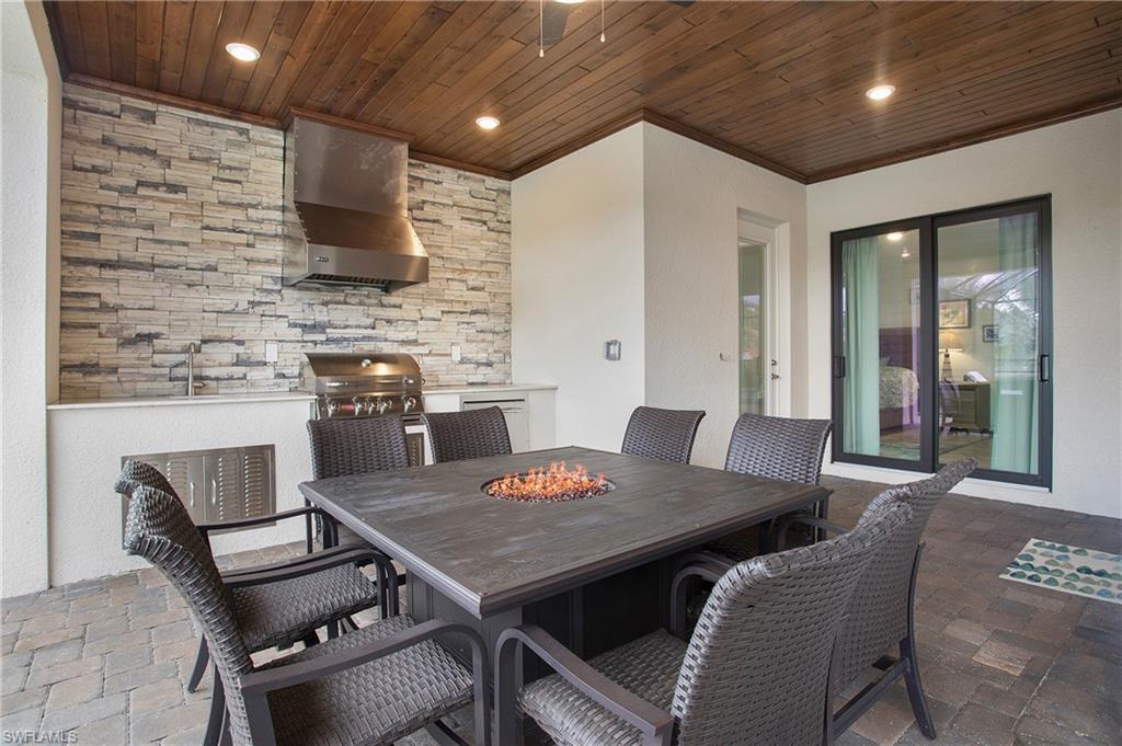 2247 Somerset Place Naples, FL 34120 - Photo 26 of 35 a view of a dining room with furniture